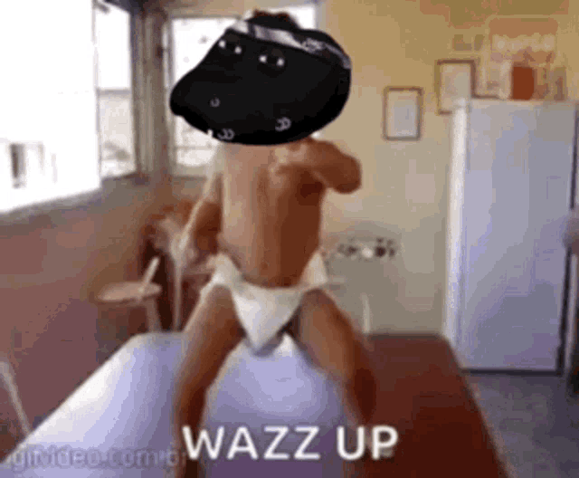 a baby in a diaper is standing on a table with the words wazz up written on the bottom