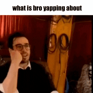 a man wearing glasses is talking on a cell phone while sitting on a couch .