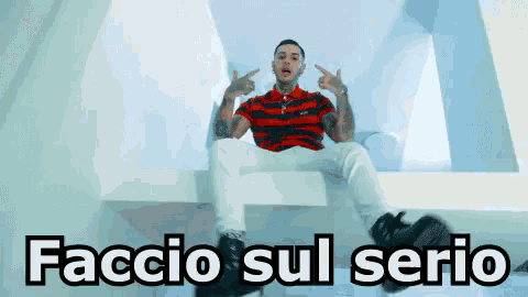 a man in a red and black striped shirt is sitting on a ledge with the words faccio sul serio written below him