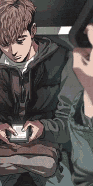 a man in a green jacket is pointing at a cell phone