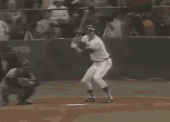 a baseball player is swinging his bat at a ball