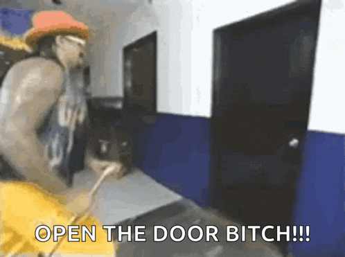 a man is standing in a hallway with the words open the door bitch