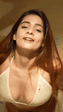 a woman wearing a white bra with a plunging neckline