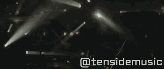 a close up of a person playing a guitar with the words @tensidemusic visible