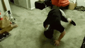 a man is doing a handstand on a carpeted floor in a living room .