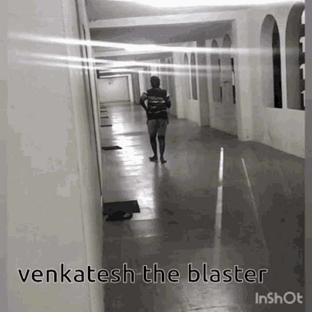 a man walking down a hallway with the words venkatesh the blaster in the corner