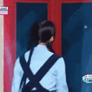 a woman with a backpack is standing in front of a door .