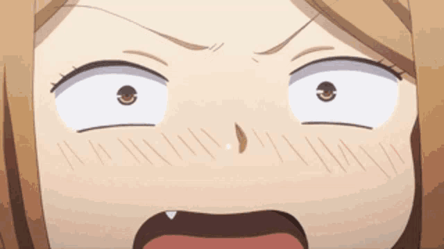 a close up of a girl 's face with a surprised look on her face .