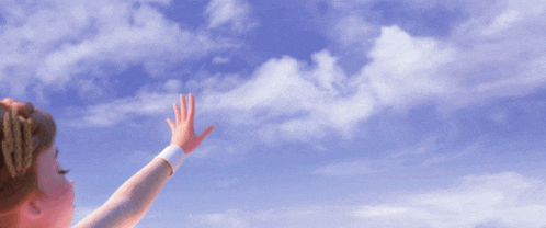 a little girl pointing up at the sky with her finger
