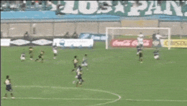 soccer players on a field with coca cola advertisements