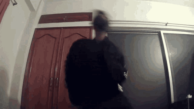 a blurry picture of a person standing in front of a closet