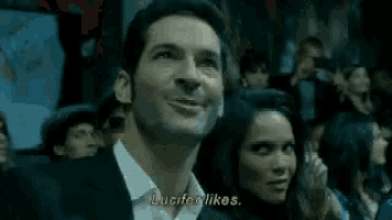 a man and a woman are in a crowd and the man is saying lucifer likes