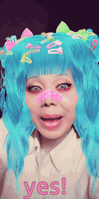 a woman with blue hair is wearing a shirt that says yes on it