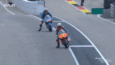 a man riding a motorcycle on a track with the words replay on the bottom