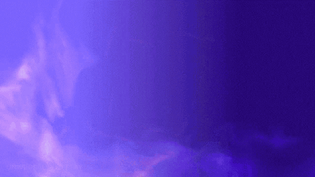 a purple background with white clouds in it