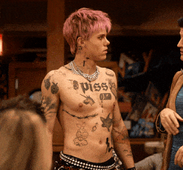 a man with pink hair has a tattoo on his chest that says " piss "