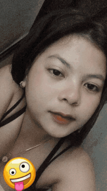 a girl with a yellow smiley face on her face
