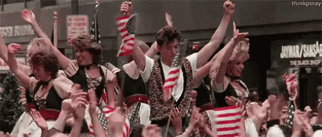 a group of people holding american flags in front of a sign that says the black shop