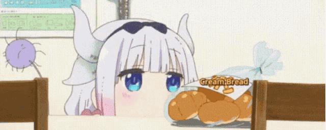 a girl with horns is peeking over a table with a bag of cream bread on it .