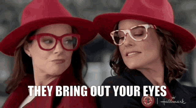 two women wearing red hats and glasses with the words `` they bring out your eyes '' .
