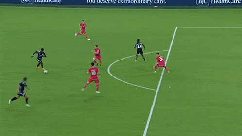 a soccer game is being played in front of an advertisement for bjc healthcare
