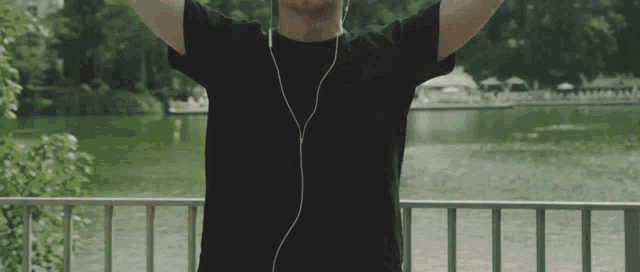 a man in a black shirt is listening to music