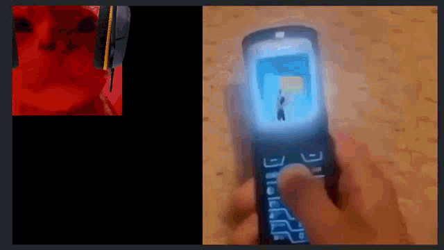a person is holding a flip phone in their hand with a picture of a person on the screen .
