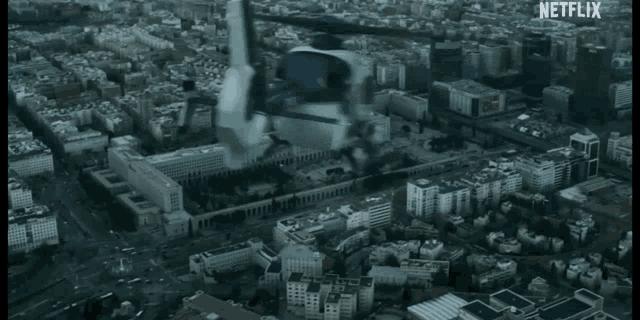 a helicopter is flying over a city with netflix written on the screen