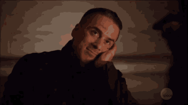 a man is smiling with his hand on his chin and the word space is on the bottom