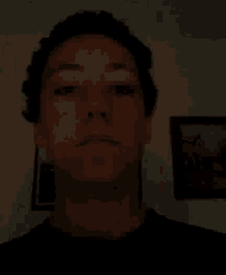 a close up of a man 's face in the dark