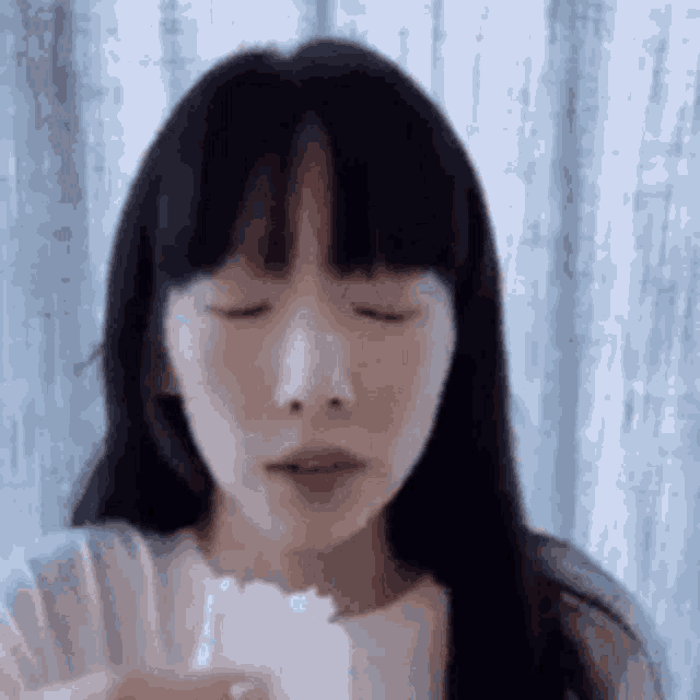 a close up of a woman eating a piece of ice cream .