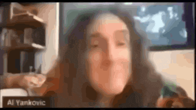 a blurry picture of a woman 's face with the name al yankovic on the bottom right corner .