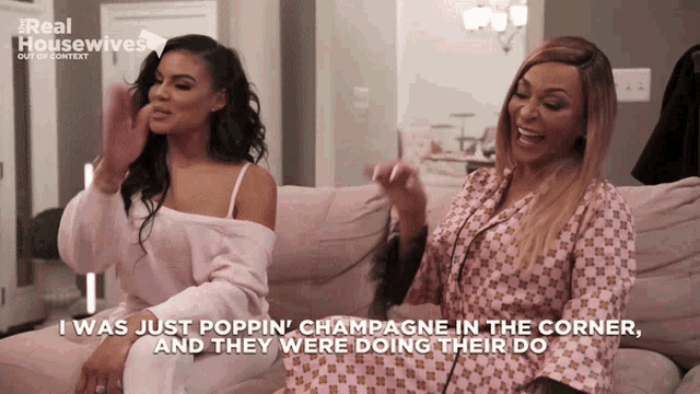 two women are sitting on a couch and one of them says " i was just poppin "