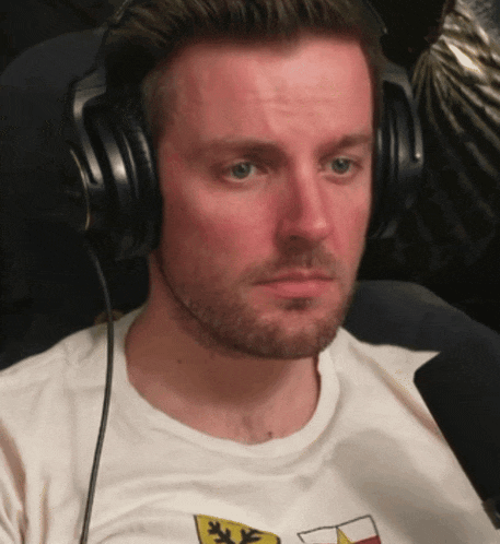 a man wearing headphones and a t-shirt that says ' x ' on it