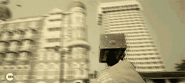 a blurred image of a city with the word zee on the bottom right