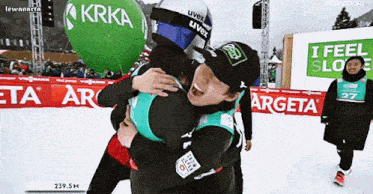 two people hugging in front of a sign that says i feel sloe