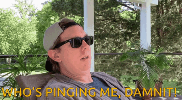a man wearing sunglasses and a hat says who 's pinging me damn it