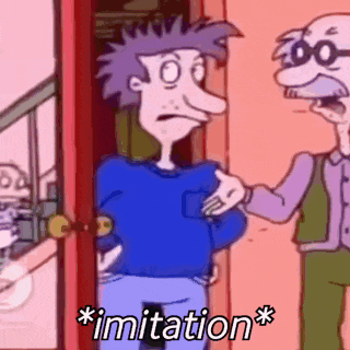 a man in a blue shirt is standing next to a man with glasses and the words imitation written on the bottom