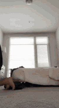 a person doing push ups on a bed in a room