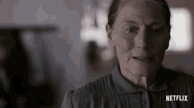 a close up of an older woman with a netflix logo on her shirt