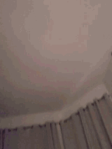 a blurry image of a person 's face with a pink background