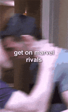 a blurry picture of a man with the words get on marvel rivals written on it