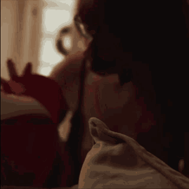 a woman is holding a baby in her arms while laying on a bed .