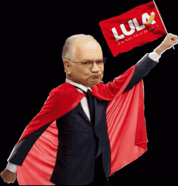 a man in a cape holds up a flag that says lula