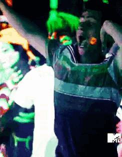 a blurry picture of a man with a mtv logo on the bottom right