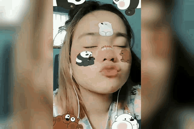 a girl with bears on her face making a kissing face