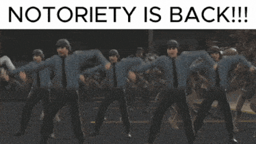 a group of monsters are running down a road with the words " notoriety is back " above them