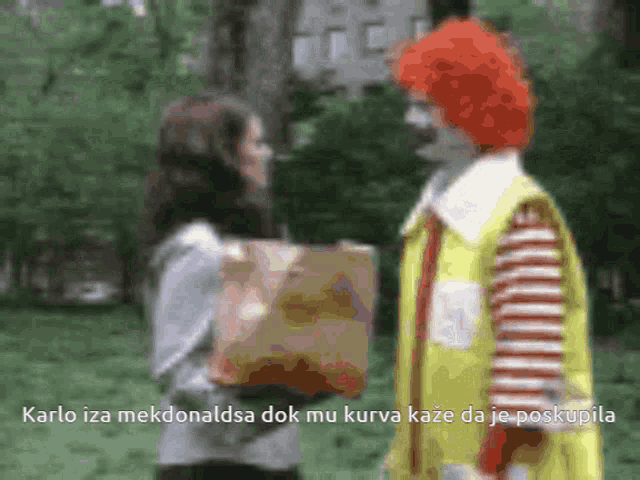 a mcdonald 's clown talking to a woman holding a bag