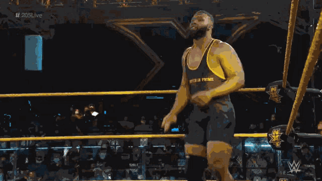 a wrestler in a black and yellow tank top that says sea power