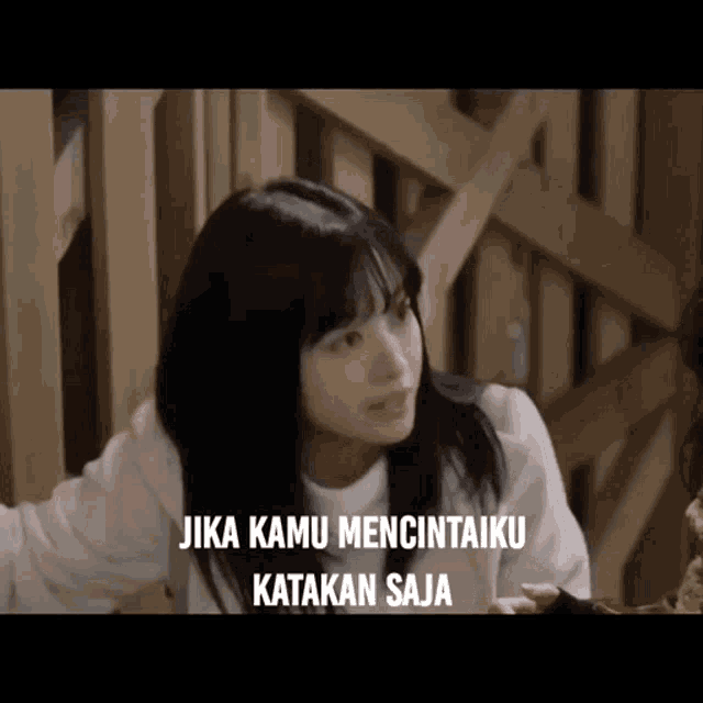 a girl with long black hair says jika kamu mencintaiku katakan saja .